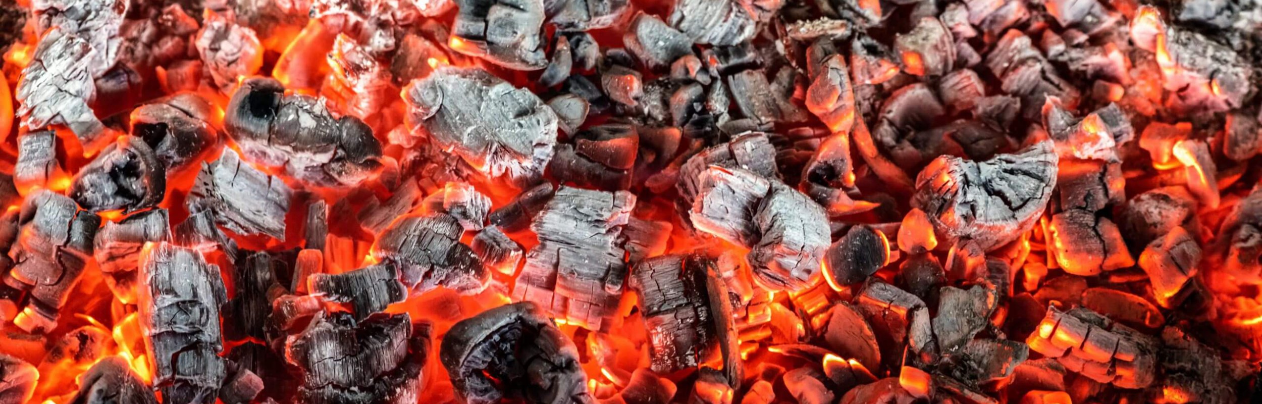 Burning coals from a fire abstract background.